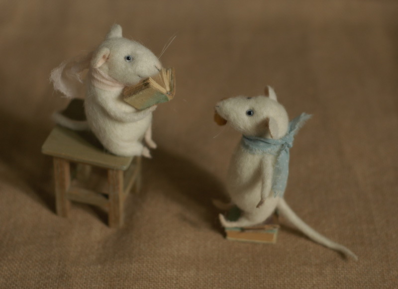 two mice reading a book