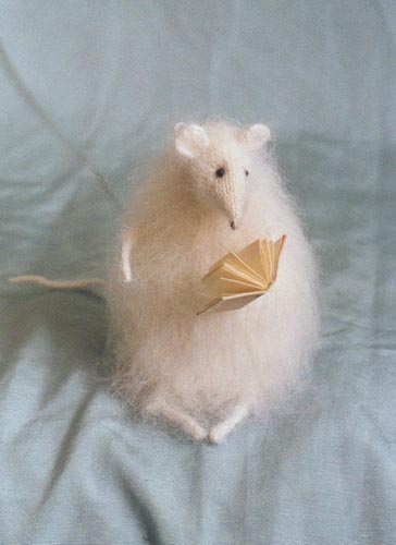 stuffed mouse reading a book