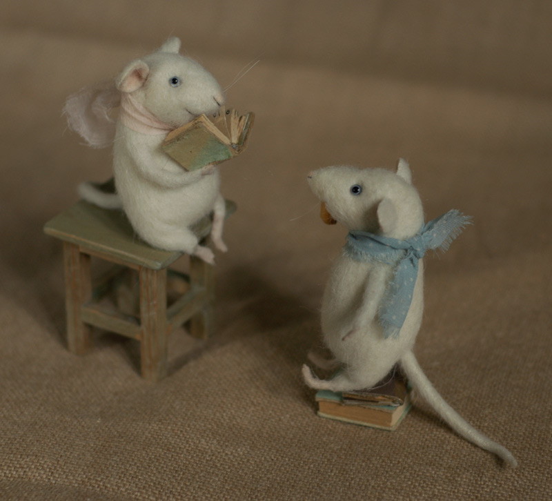 two mice reading a book