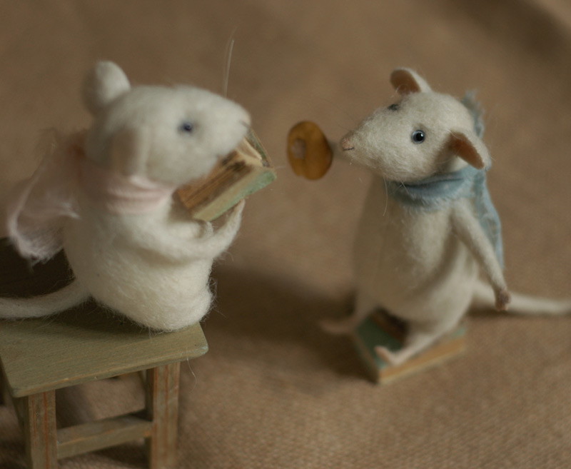 two mice reading a book