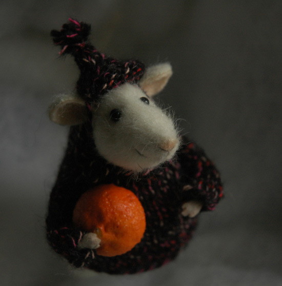 mouse holding a tangerine