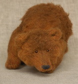 red stuffed crouching bear