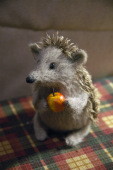 stuffed hedgehog holding apple
